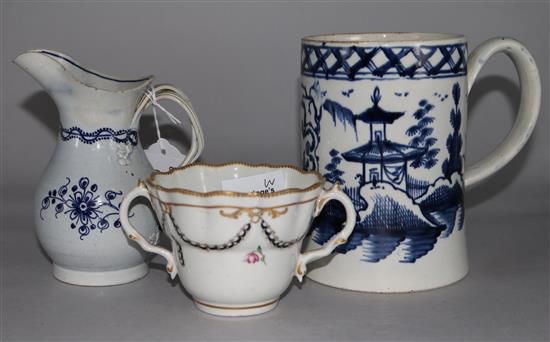 A Liverpool pearlware cylindrical mug, a Worcester two handled chocolate cup painted with harebell swags and a pearlware jug (3)